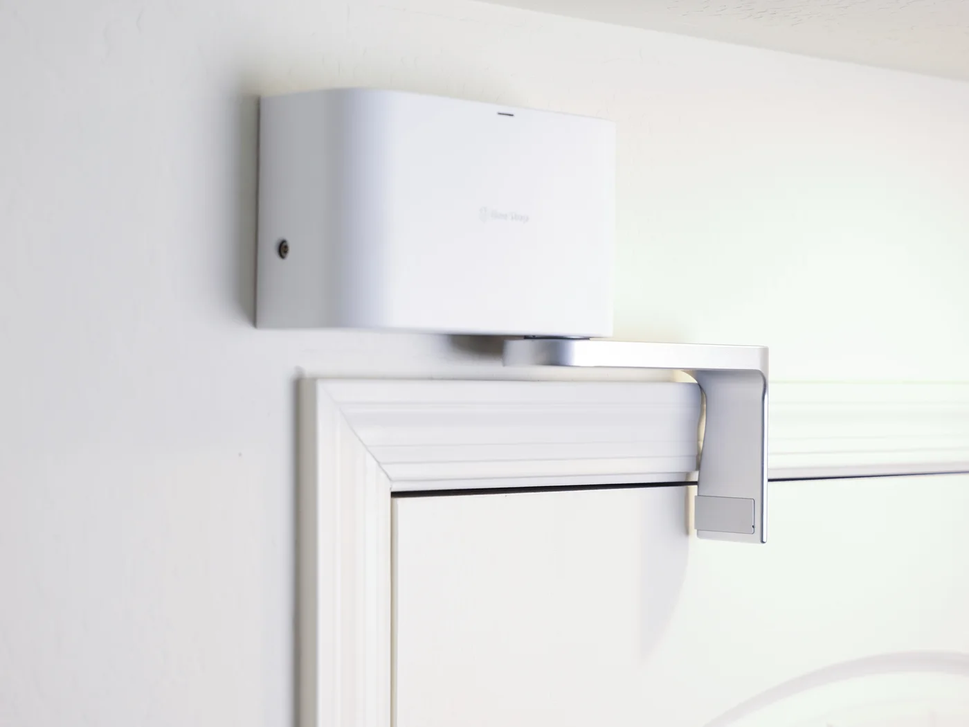The Guard in Deadbolt mode, arm locked flat across the top of the door